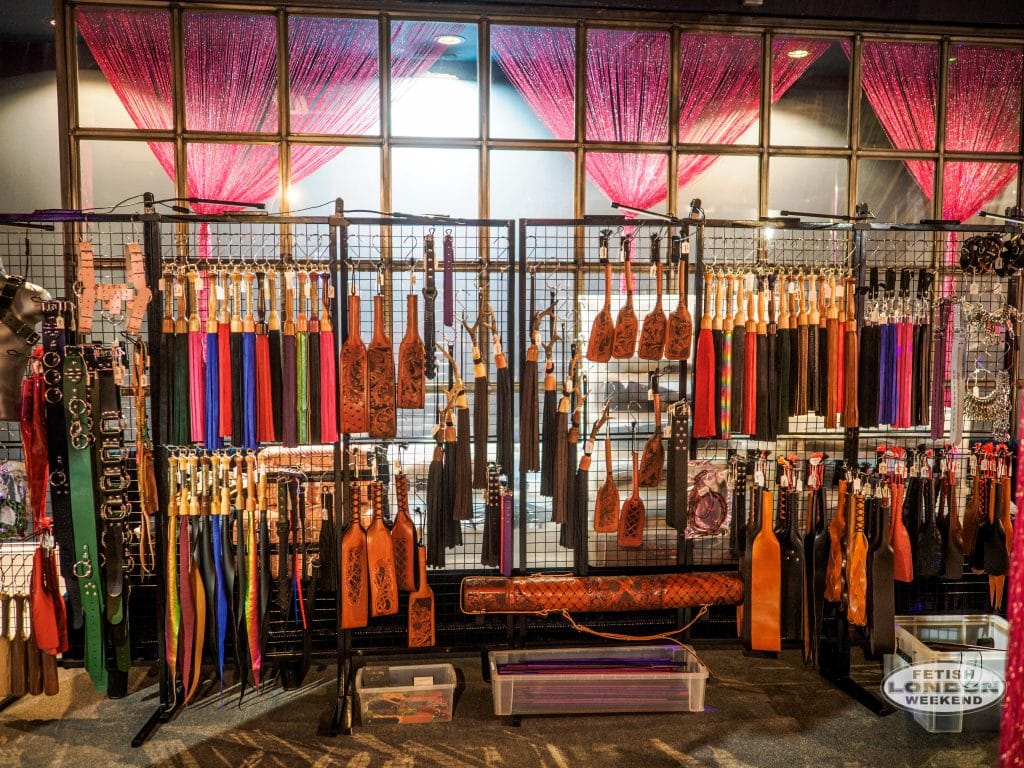 Rows of colourful floggers and impact toys on display at the Fetish Fair
